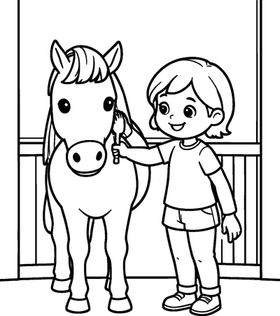 A smiling girl holds a brush against the neck of a horse standing in front of a wooden stable fence.