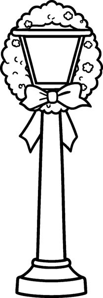A tall street lamppost has a round wreath hung around its lantern and a big ribbon bow tied beneath it.